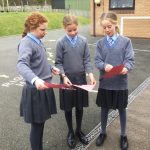 students looking at the red pieces of paper