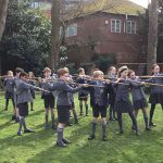 students holding spears