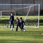 boys reaching for football